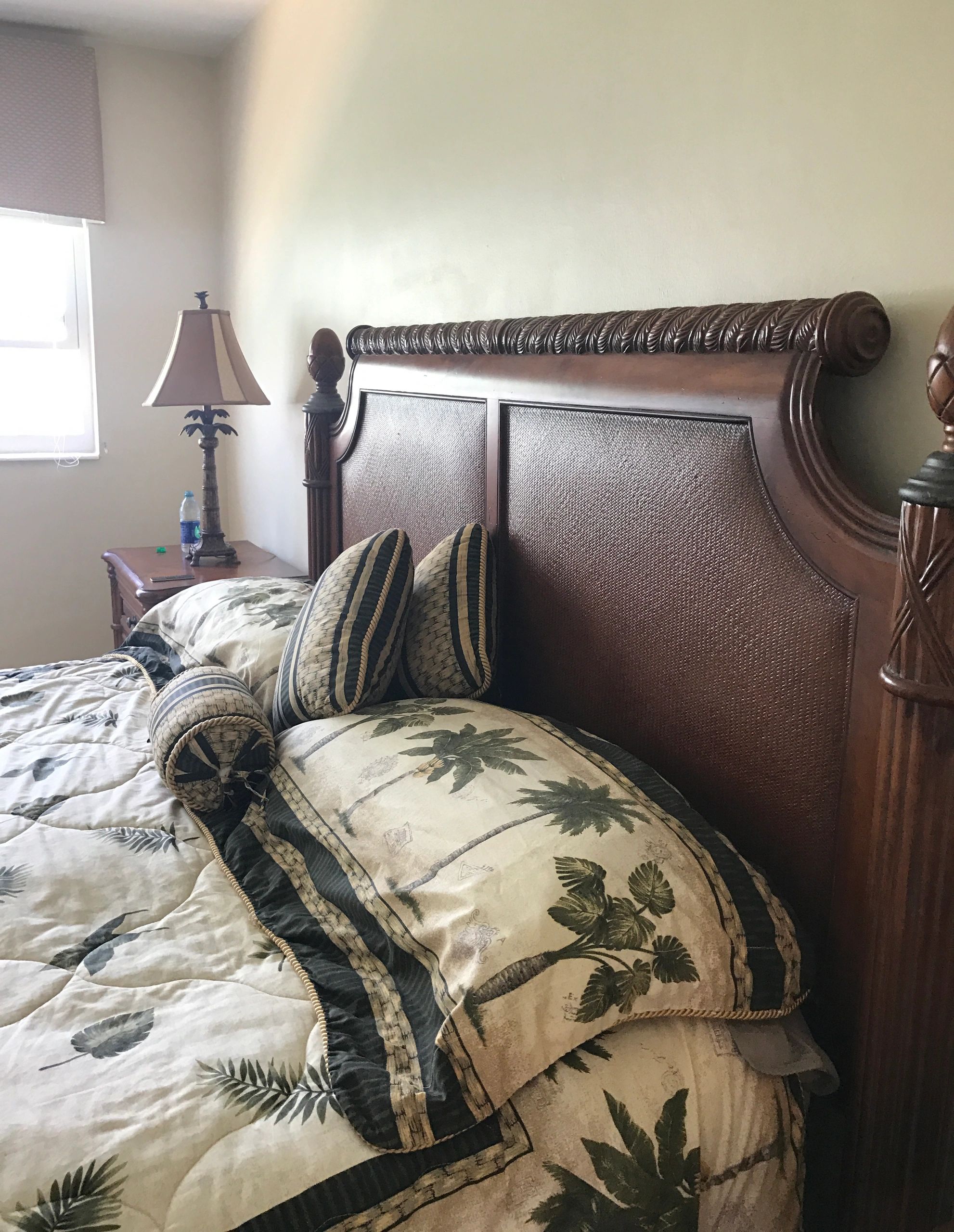 Bedroom with ornately carved wooden bed
