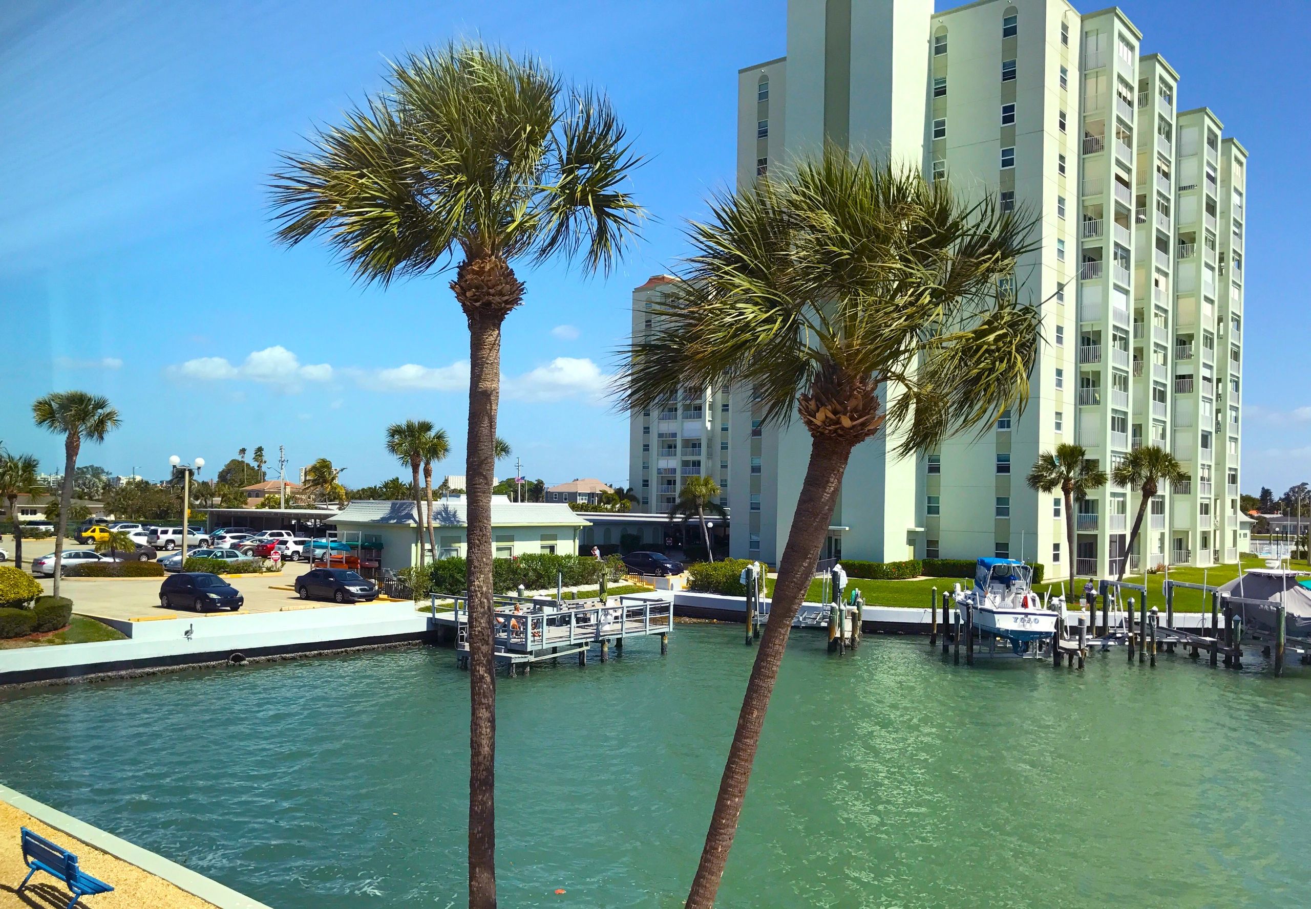 Waterfront community with canal, boats and palm trees
