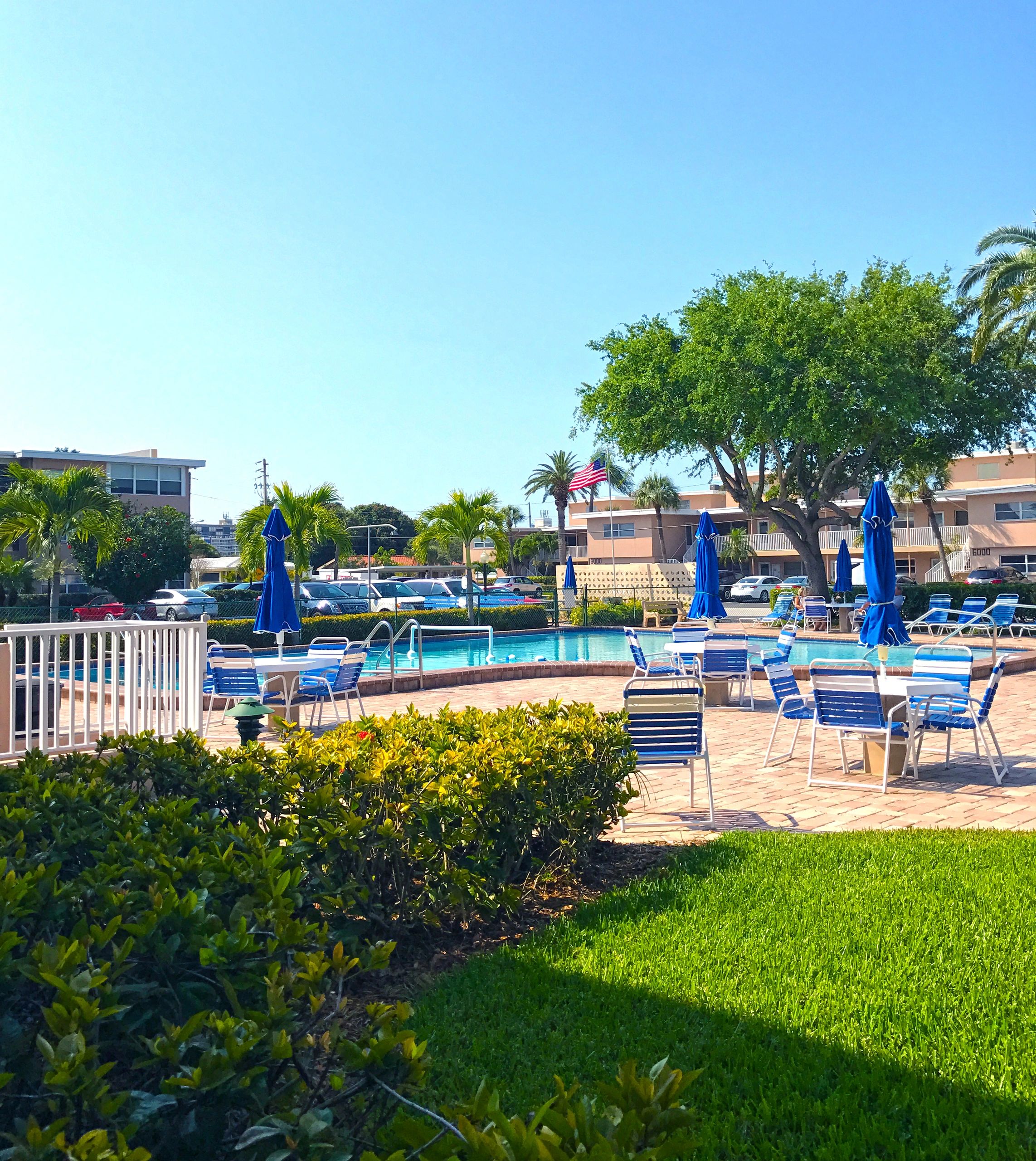Sunny resort pool with lounge chairs