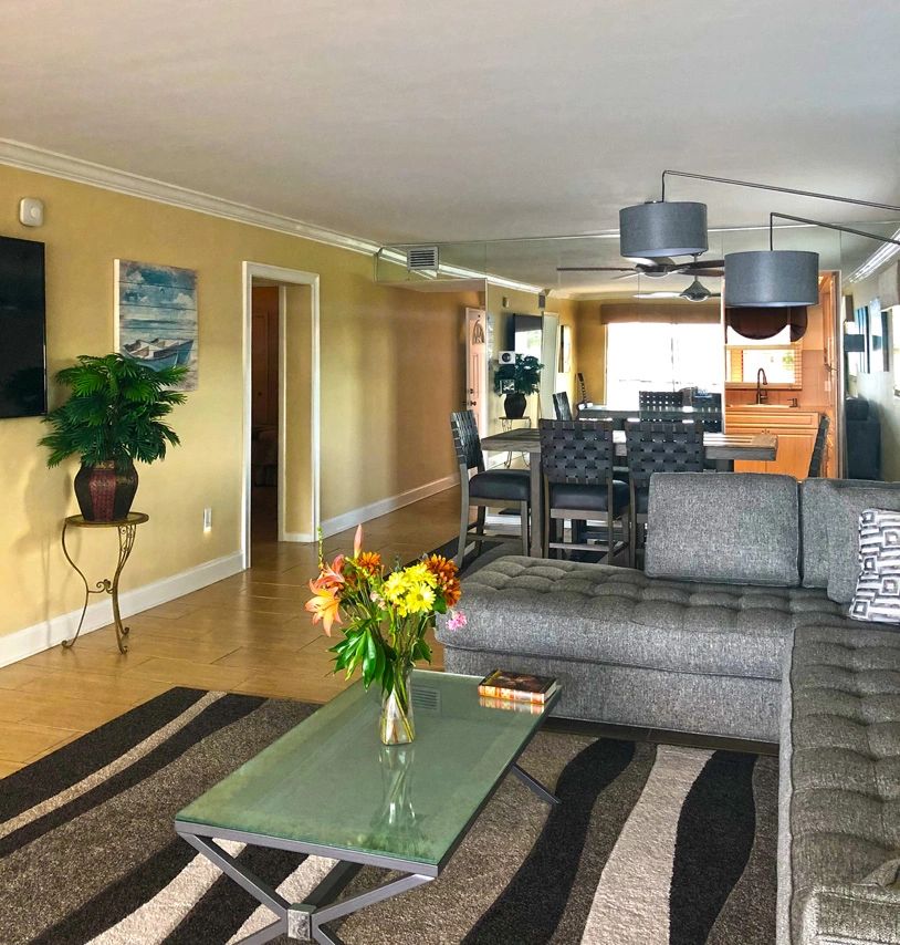 Living space with yellow accent wall and sectional sofa