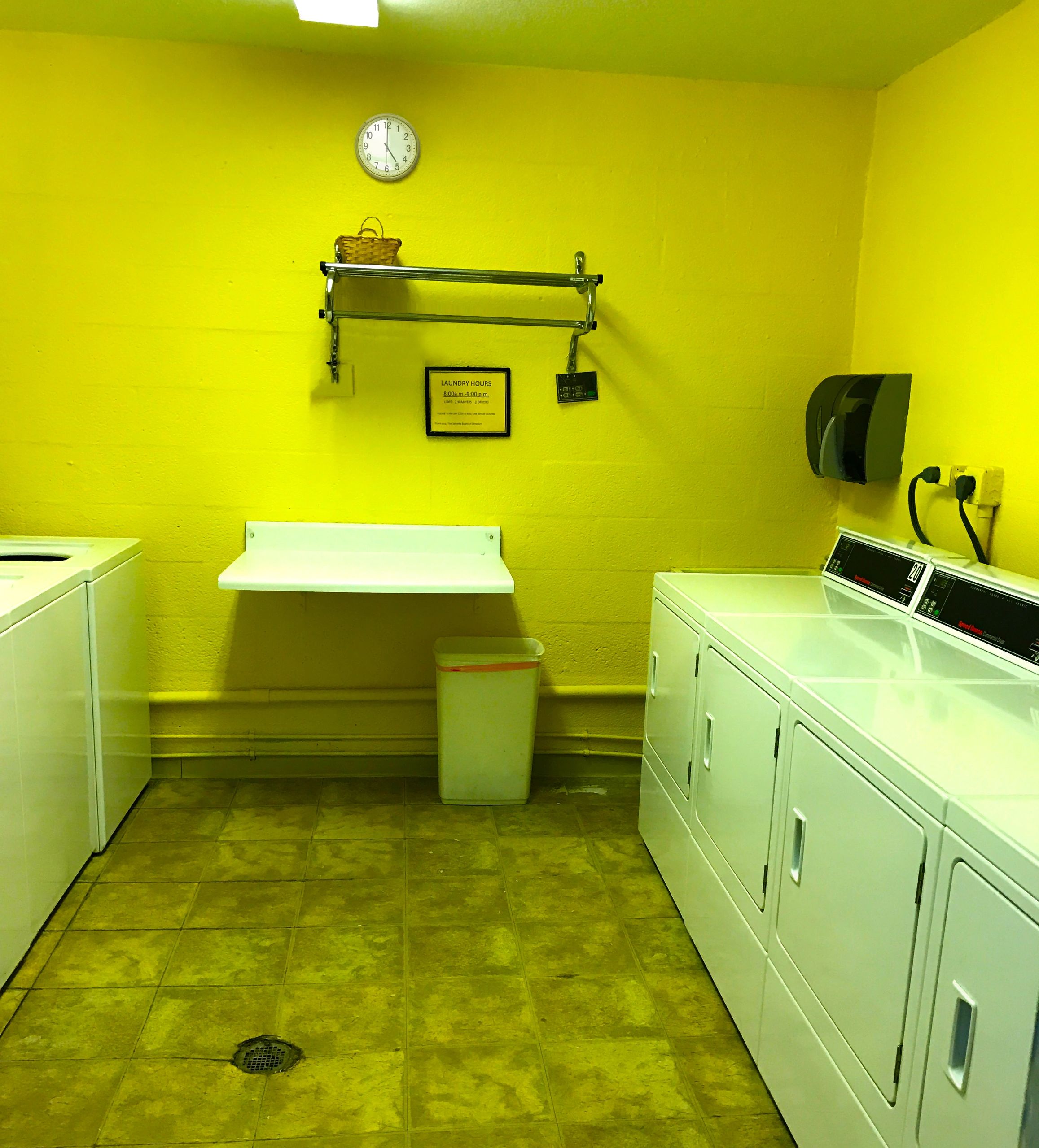 Bright laundry room with washers and dryers