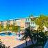 Beachfront resort with yellow buildings and palm trees