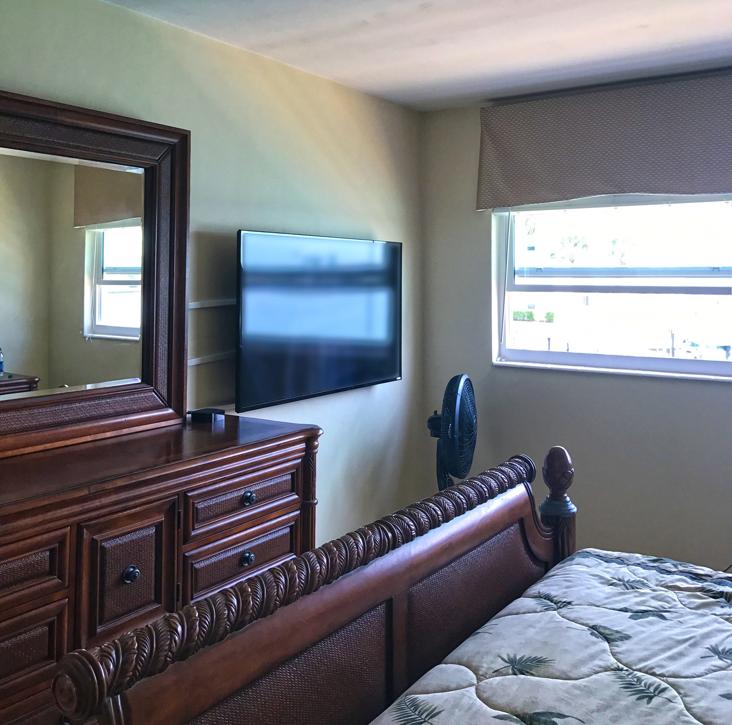 Bedroom with wall-mounted flat-screen TV
